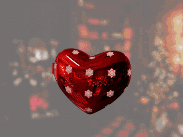 a red heart with the word help written inside of it