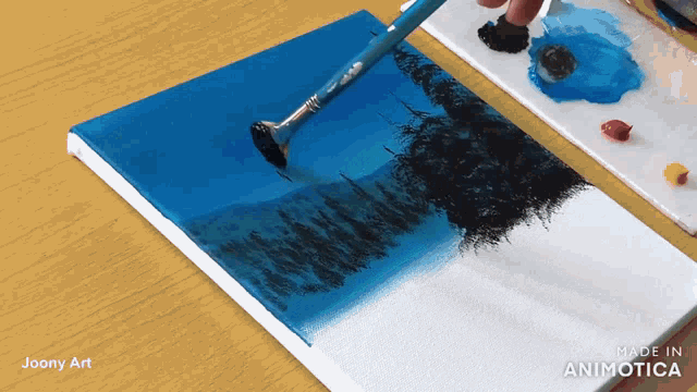 a painting of trees is being painted on a canvas by joony art