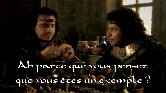 two men are sitting at a table with the words ah parce que vous pensez que vous êtes un exemple