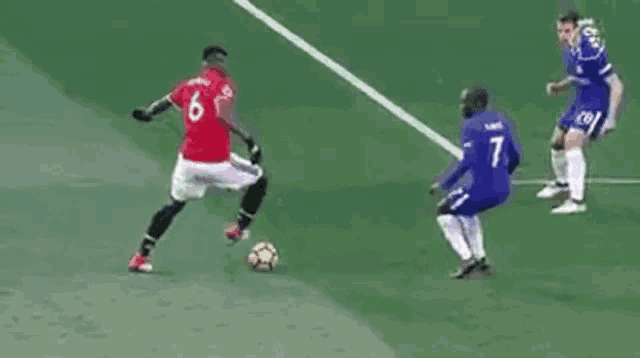 a soccer player in a red jersey is kicking a soccer ball .