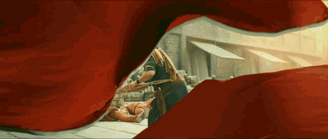 a man is kneeling down with a sword in his hands
