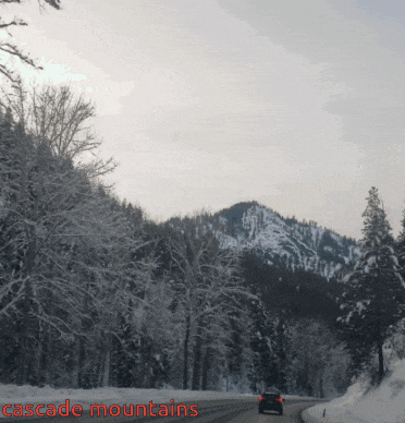 a car is driving down a snowy road with the words cascade mountains visible