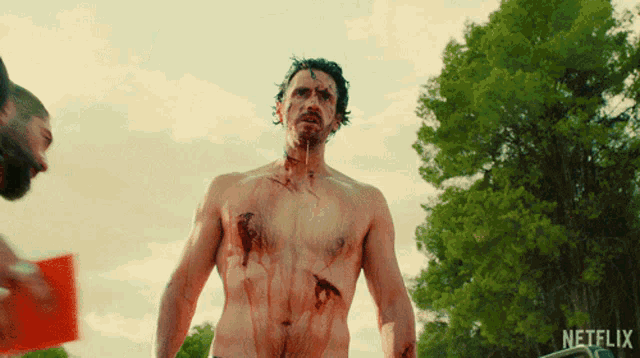 a shirtless man is standing in front of a sign that says netflix on it