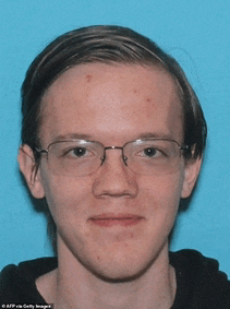 a young man wearing glasses and a black shirt poses for a photo