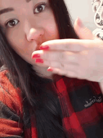 a woman wearing a plaid shirt that says abercrombie and fitch
