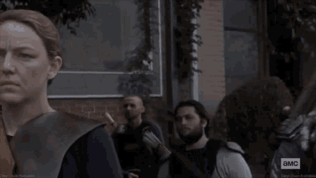 a woman is holding a bow and arrow in a scene from a tv show called a.m.c