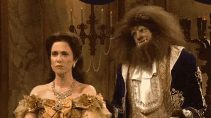 a man and a woman are dressed as beauty and the beast .