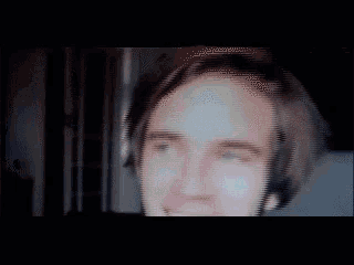 a blurry image of a man 's face with a striped background