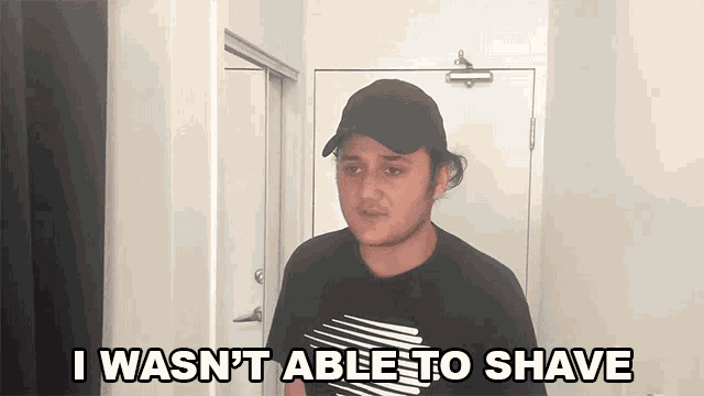 a man wearing a black hat and a black shirt says i wasn 't able to shave