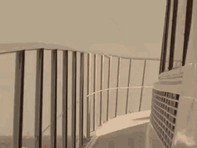 a man without a shirt is jumping off a balcony railing .