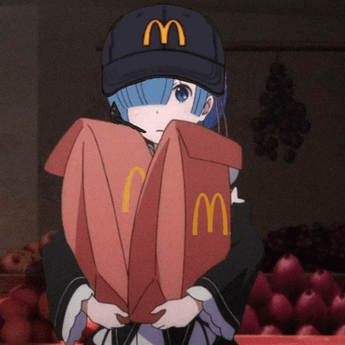 a girl wearing a mcdonald 's hat is holding a mcdonald 's box