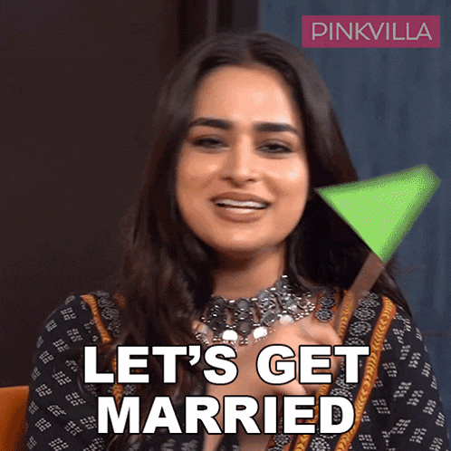 a woman says let 's get married while holding a green object