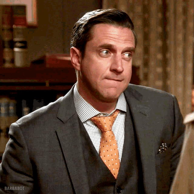 a man in a suit and tie has barbabot written on the bottom