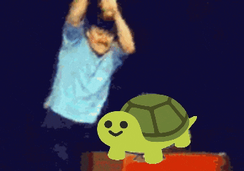 a man in a blue shirt is standing next to a yellow turtle with a smiling face
