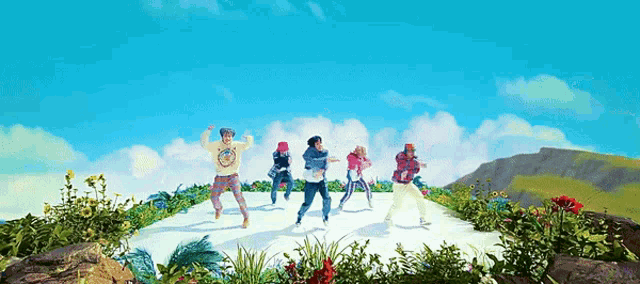 a group of people are dancing in front of a mountain and flowers