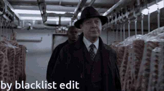 a man in a suit and hat is walking through a meat locker with the words by blacklist edit above him