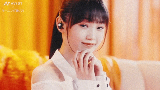 a woman wearing a white shirt with avidt written on the bottom left