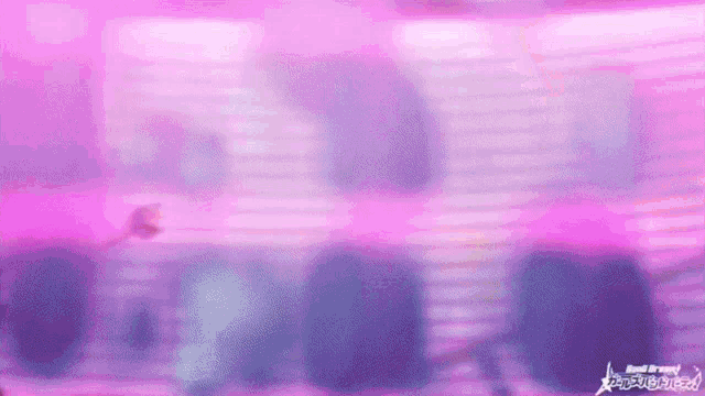 a purple and blue background with a blurred image of a person standing in front of a pink light .