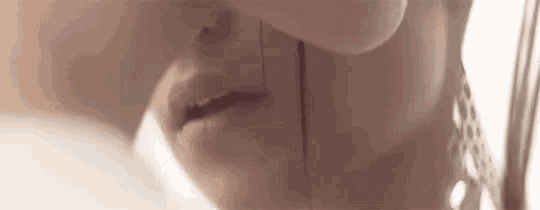 a close up of a woman 's face with a tear running down her cheek .