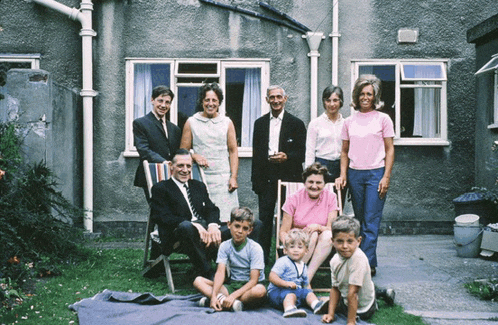 a family posing for a picture in front of a building