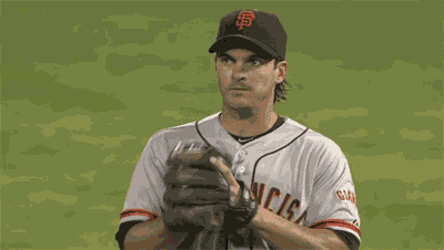 a san francisco giants baseball player looks at the scoreboard