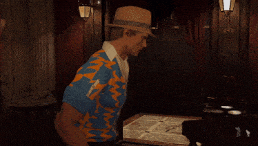 a man wearing a straw hat and a blue and orange shirt stands in a room