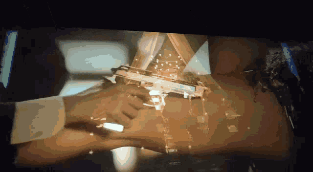 a man is holding a gun in front of a woman 's waist .