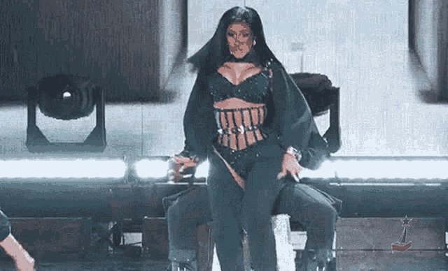 a woman in a corset is sitting on a man 's lap on a stage .