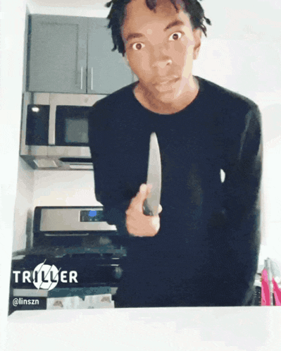 a man in a black shirt is holding a knife in front of a stove with triller written on the bottom