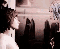 two women are looking at each other in a room .