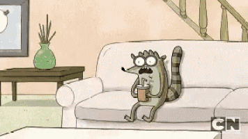 a cartoon raccoon is sitting on a couch drinking a drink .