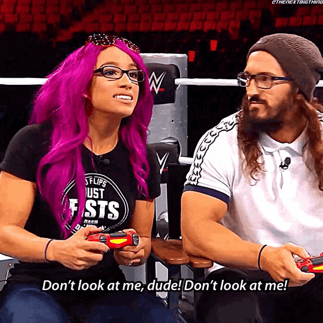 a woman with purple hair is playing a video game while a man says don 't look at me dude