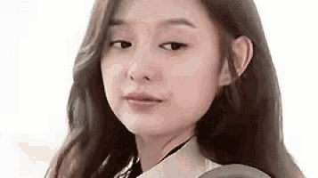 a close up of a young woman 's face with long hair .