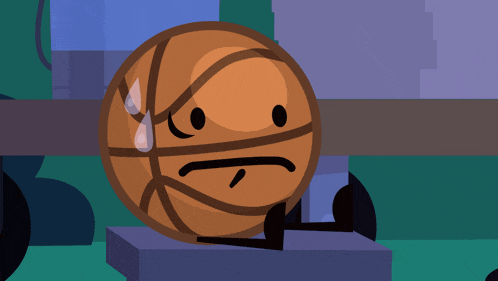 a basketball with a sad face is sitting on a block