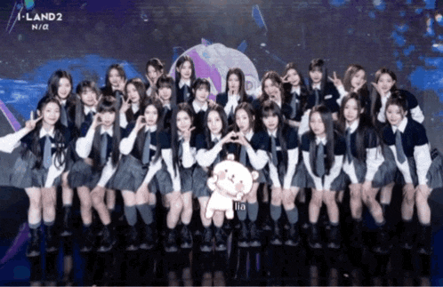 a group of girls posing for a picture with a teddy bear in the middle and the words i land 2 n / a