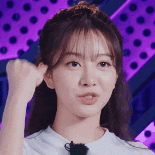 a close up of a woman 's face against a purple background