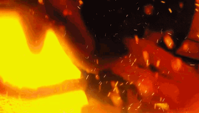 a close up of a fire with lots of sparks coming out of it