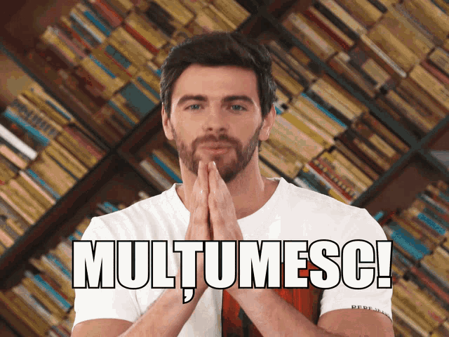 a man with his hands folded in front of a book shelf with the words multumesc written on the bottom