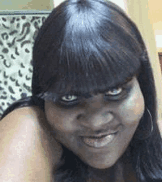 a woman with a very angry look on her face is smiling .