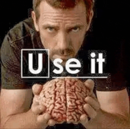 a man is holding a brain in his hands with the words `` use it '' written on it .