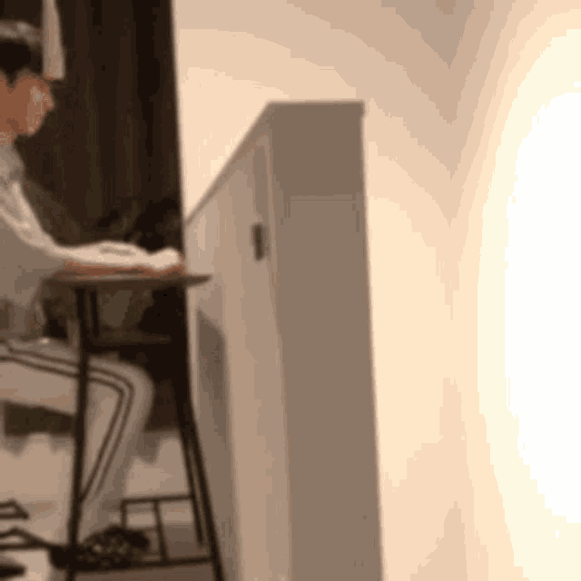 a man is sitting at a desk with a laptop on it .