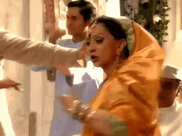 a woman in a yellow dress is being slapped by a man