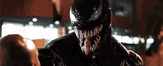 a close up of a person being attacked by a venom monster .
