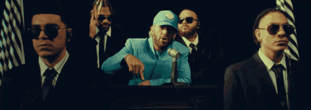a man with a beard is wearing a blue shirt and a blue hat