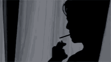 a silhouette of a person standing in front of a window