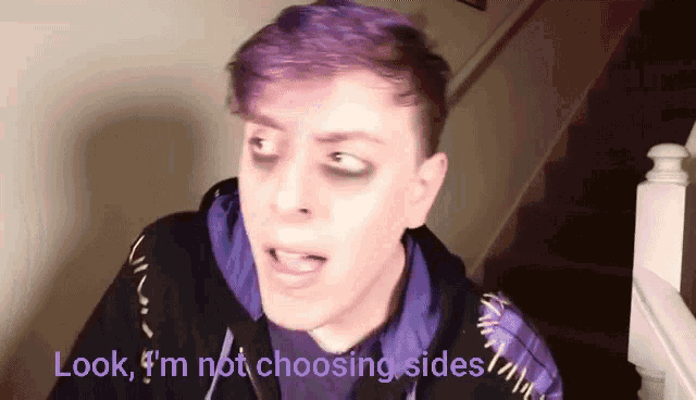 a man with purple hair and black eyeshadow says look i 'm not choosing sides