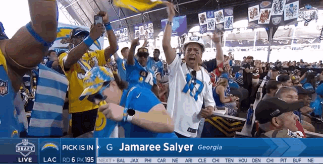 a crowd of people watching a football game with the name jamaree salyer in the upper right corner
