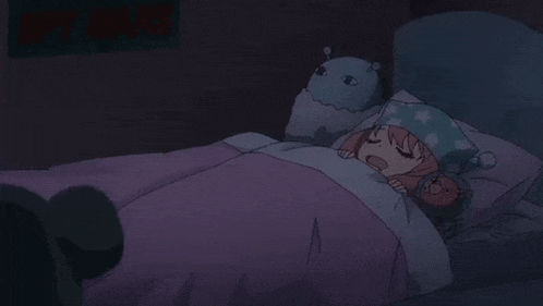a girl is sleeping in bed with a stuffed animal .