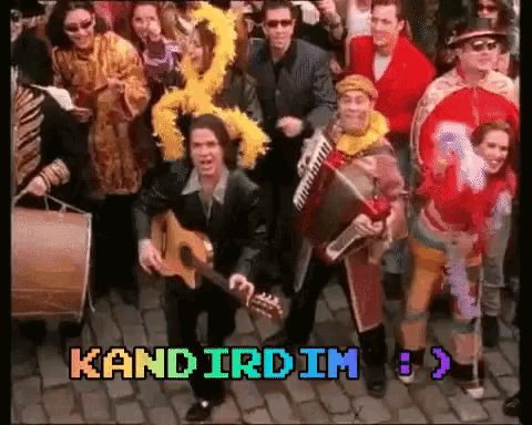 a group of people playing musical instruments with the words kand irdim in the upper right corner