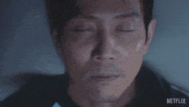 a close up of a man 's face with netflix written on the bottom right